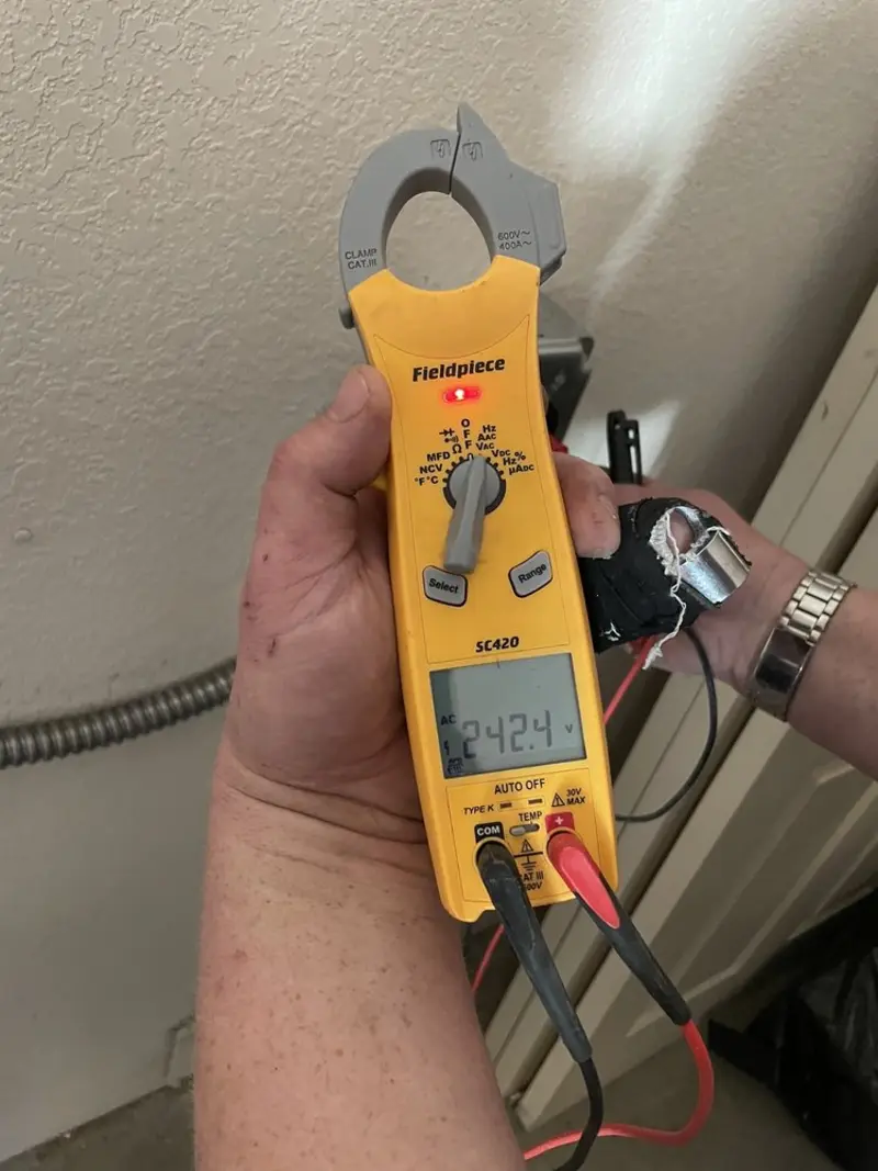 Voltage testing with clamp meter during Electrical Installation Services in Rochester